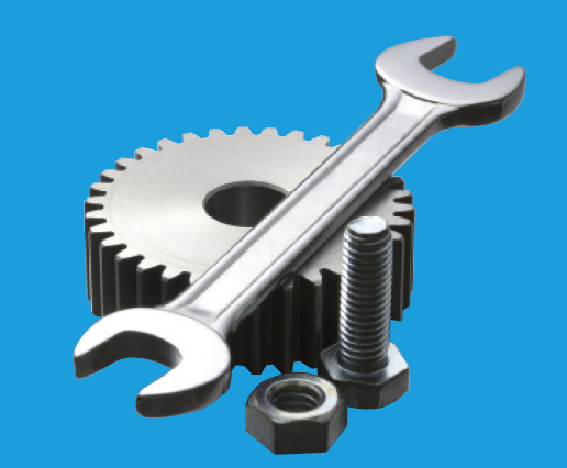 A photo of a gear, wrench, and nut and bolt set.