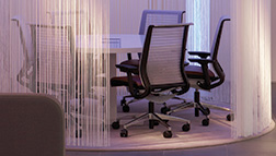 A photo shows chairs arranged around a round table.