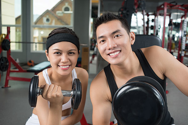 Photo shows Kristi Kwan and Yuan Martin at their fitness center.