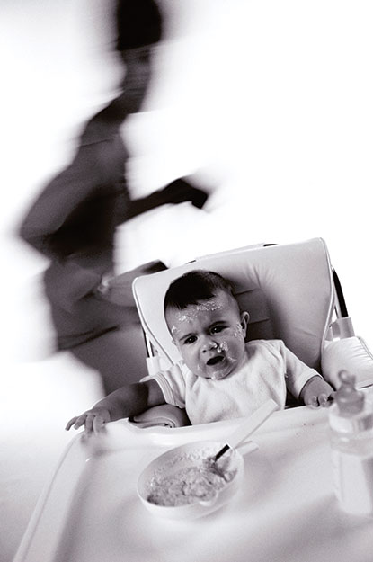 Photo shows a toddler seating on a chair and crying.