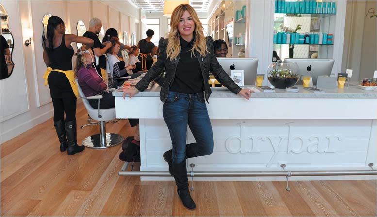 Alli Webbstanding at a drybar salon counter.