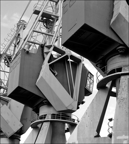 An aerial view of the steel towers of this pair of cranes fixed to the shipyard.