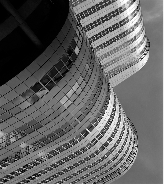 An aerial view of the exterior work of a skyscraper architecture building with mirror work.