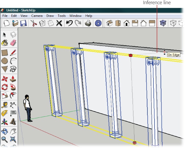 The height of these columns is set to match the height of the wall. After you select the columns and click the Scale tool, the cursor moves to a point at the top of the wall. An inference line appears when the columns are scaled to the same height as the wall.