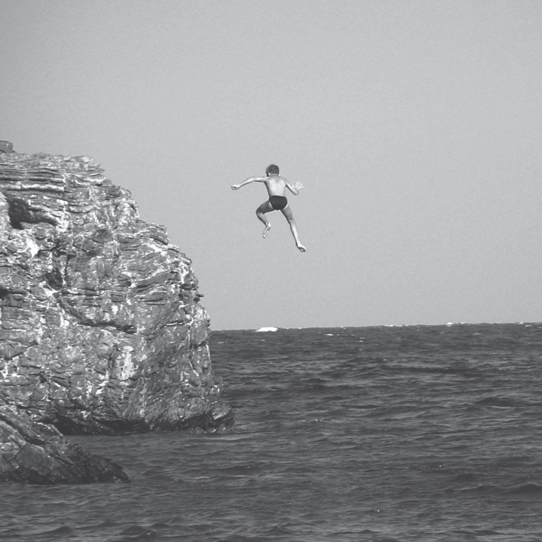 A photograph of a person jumping in water.