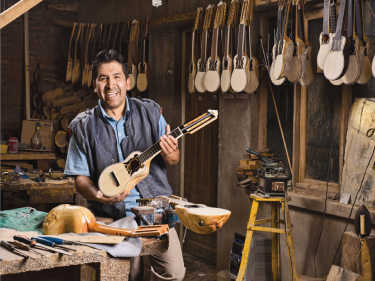 Photo showing a man in his musical instruments store.