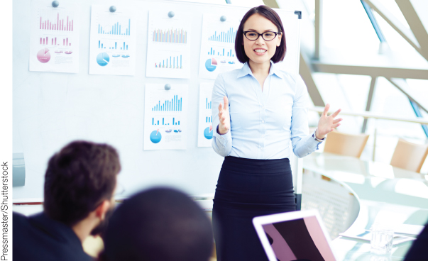 Photo illustration of a young woman presenting in front a group.