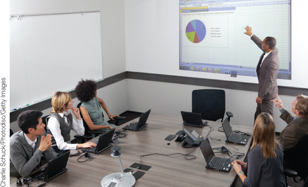 Photo illustration of office executives participating a presentation. Certain statistics are displayed on a big screen.