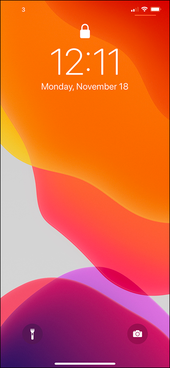 Screen capture depicting iPhone home screen locked with wallpaper, date, time, and flash light and camera options.