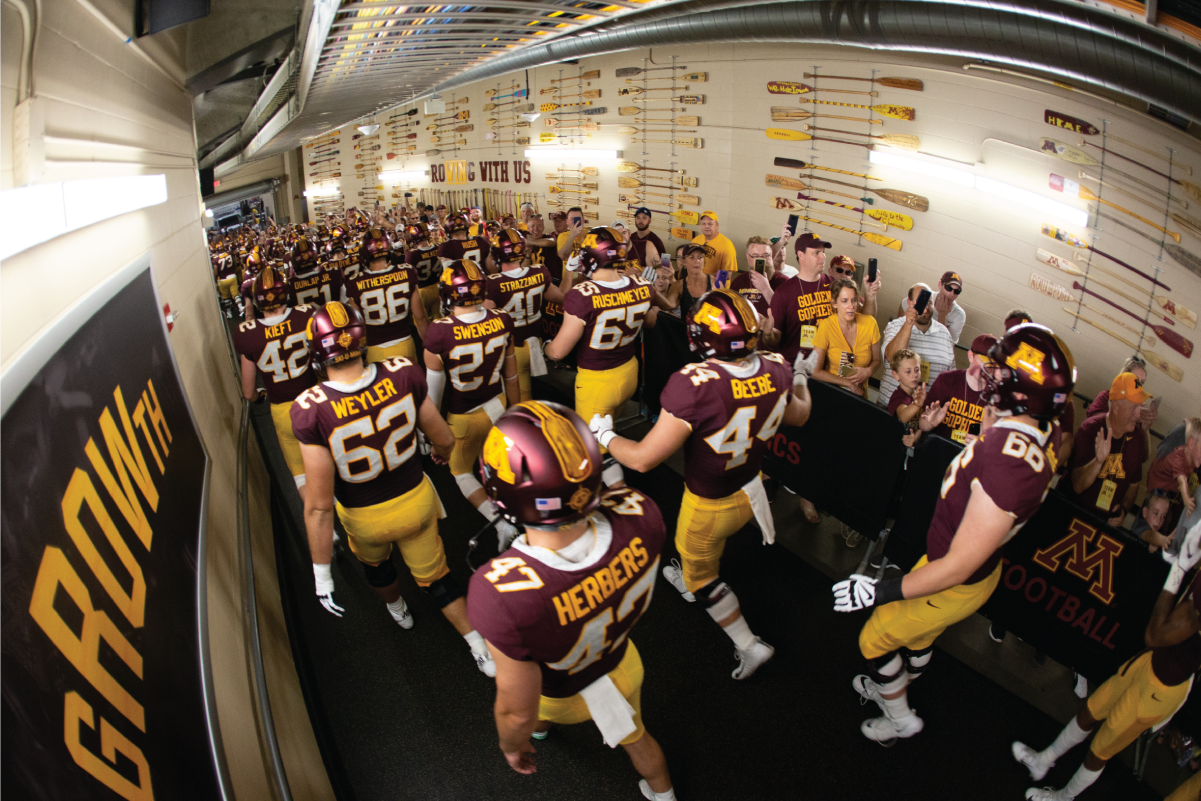 Photograph of a group of team players walking in a corridor.