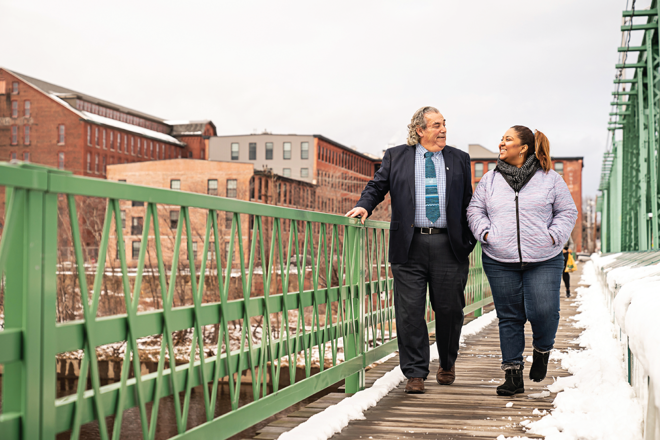 Photograph of two generations of immigrants: Danaris Mazara walks with Frank Carvalho.