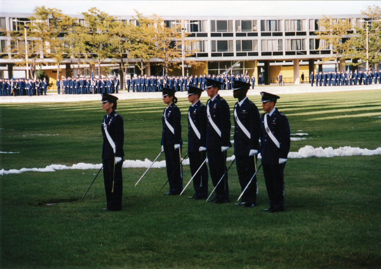 A photograph of leading the 4,000-member Cadet Wing during noon meal formation at the United States Air Force Academy.