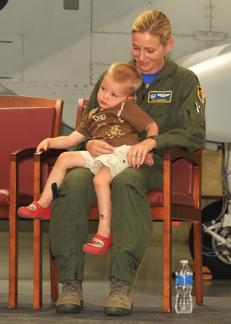 A photograph of my change of command ceremony, taking command of the 355th Operations Support Squadron at Davis-Monthan Air Force Base in Arizona. My son decided he would prefer to sit with me on stage.