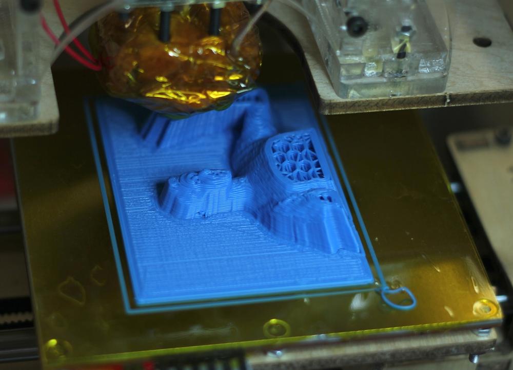 The MakerBot midway through printing out our scan. You can see the honeycomb pattern MakerBot uses to fill in large areas.