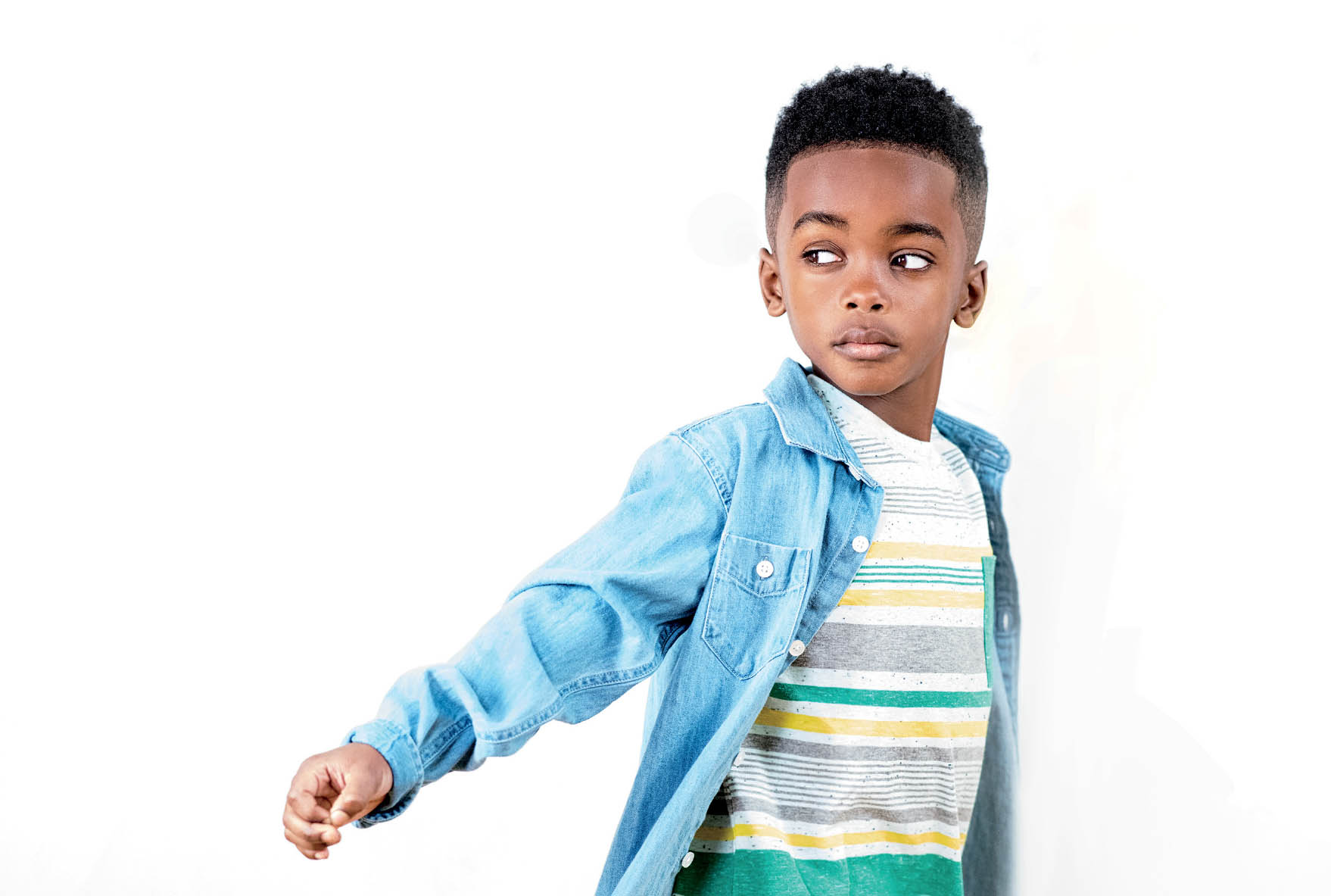 Premium PSD | African american boy in blacksmith attire overwhelmed child  with wavy hair poses gracefully on pastel turquoise background