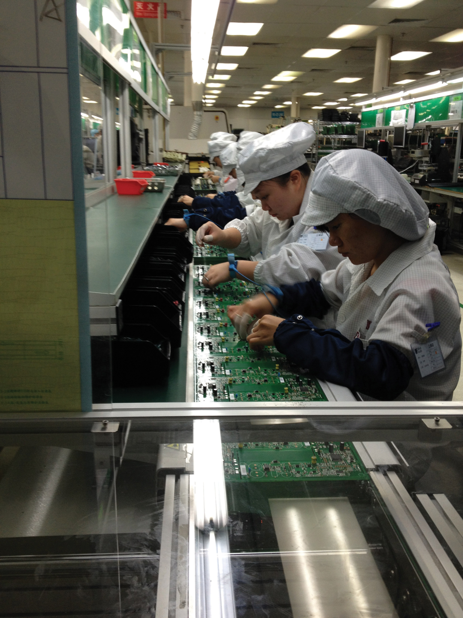 Factory workers in China assemble circuit boards. (Photo courtesy Dragon Innovation)